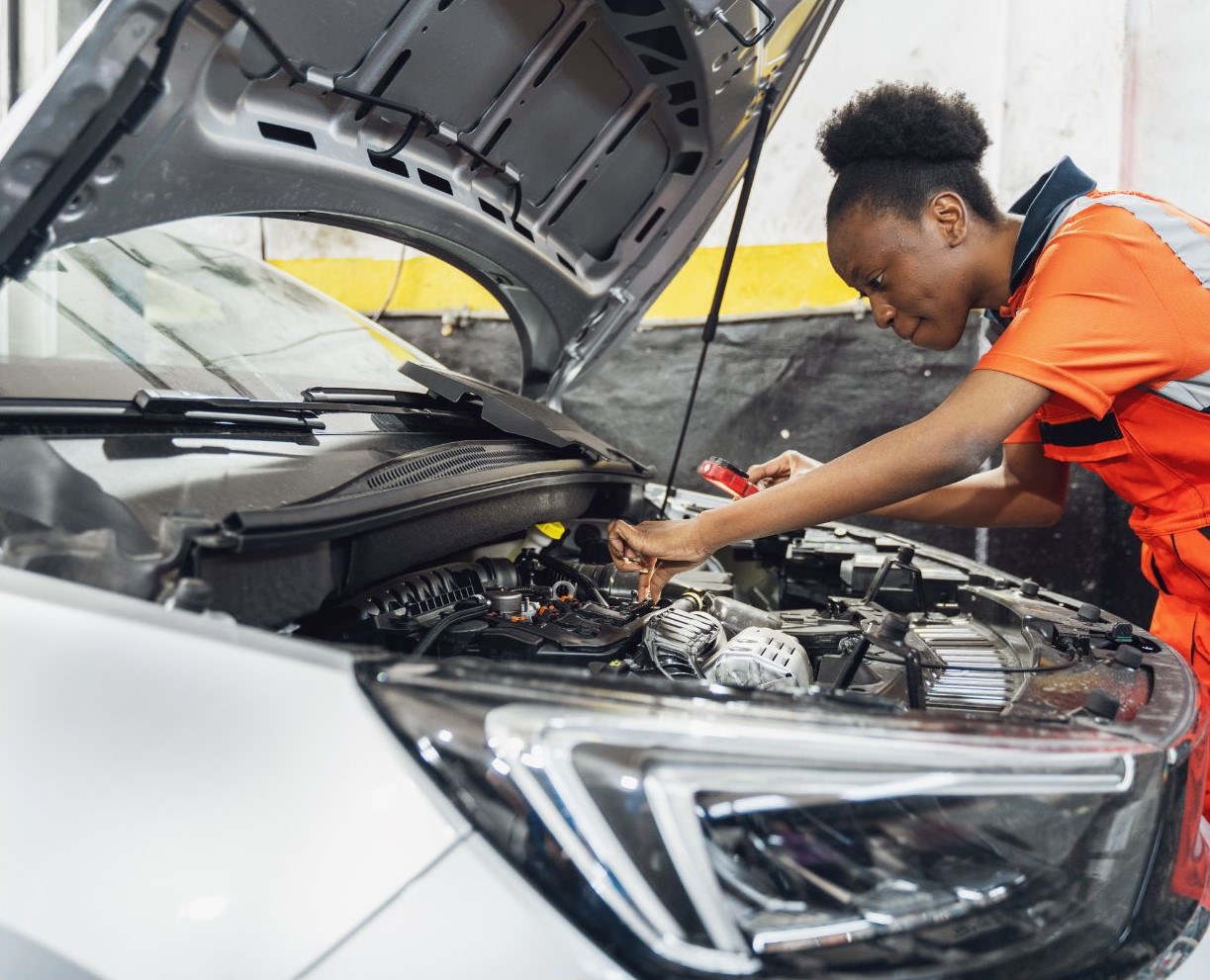 Woman working on car